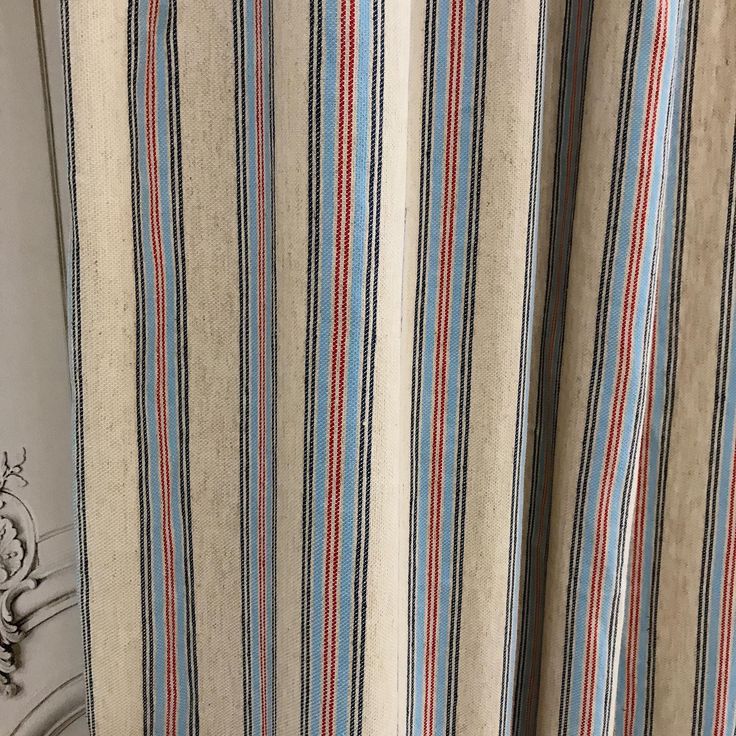 the curtain is striped with blue and red stripes