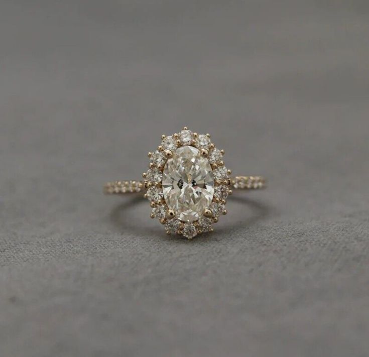 an oval shaped diamond ring with two rows of diamonds around it