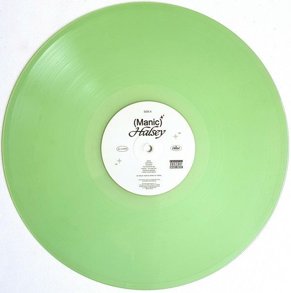 a green vinyl record on a white surface