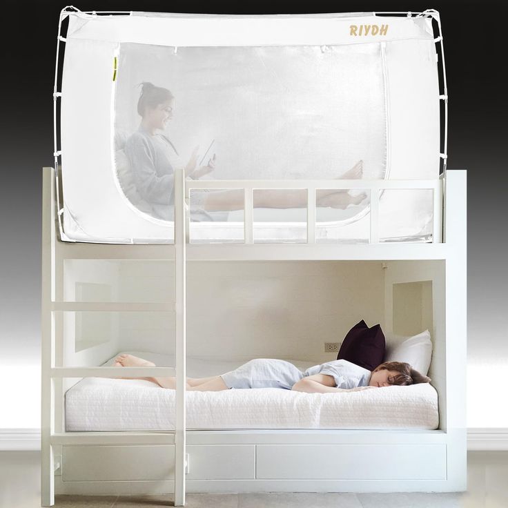 there is a woman laying on the bottom bunk bed and another person lying down reading