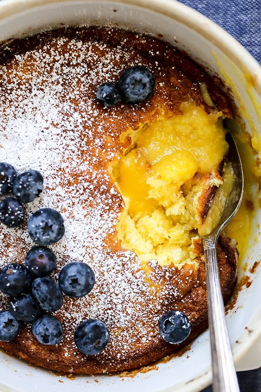 a bowl filled with blueberries and topped with powdered sugar