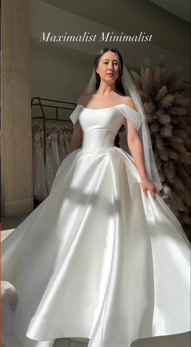 a woman in a white wedding dress posing for the camera