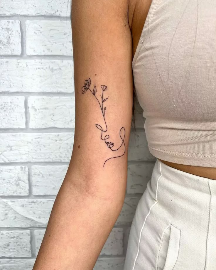 a woman's arm with a flower tattoo on the left side of her arm