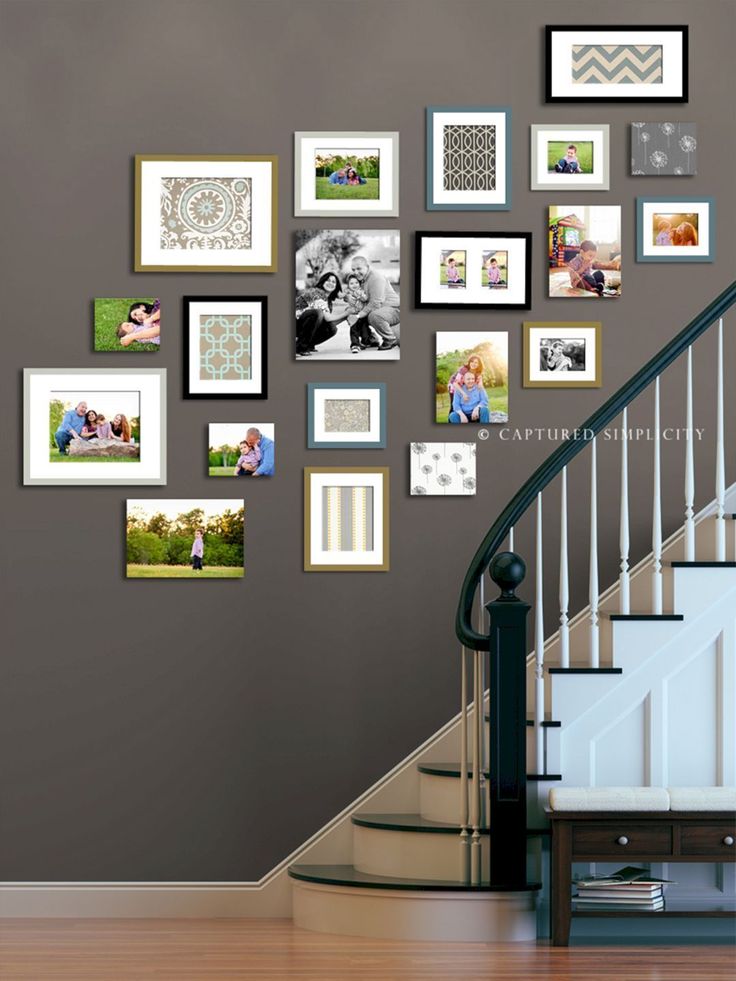 a staircase with multiple frames on the wall and pictures hanging on the wall above it