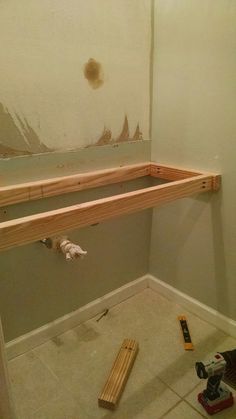 the unfinished shelf is being installed on the wall