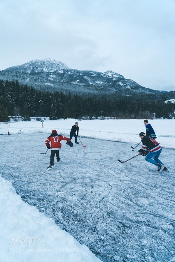 several people are playing hockey in the snow