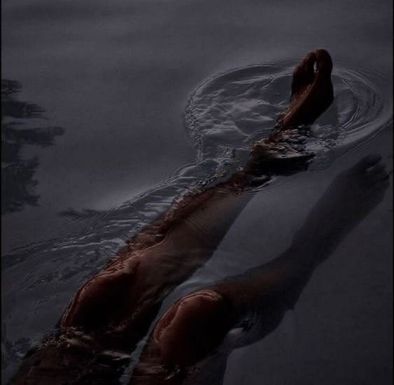 a person floating in the water with their feet up