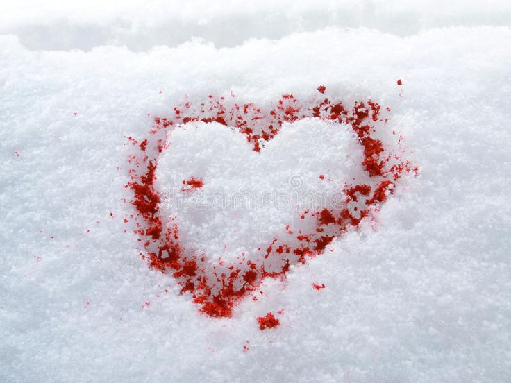 a heart shaped in the snow with blood on it