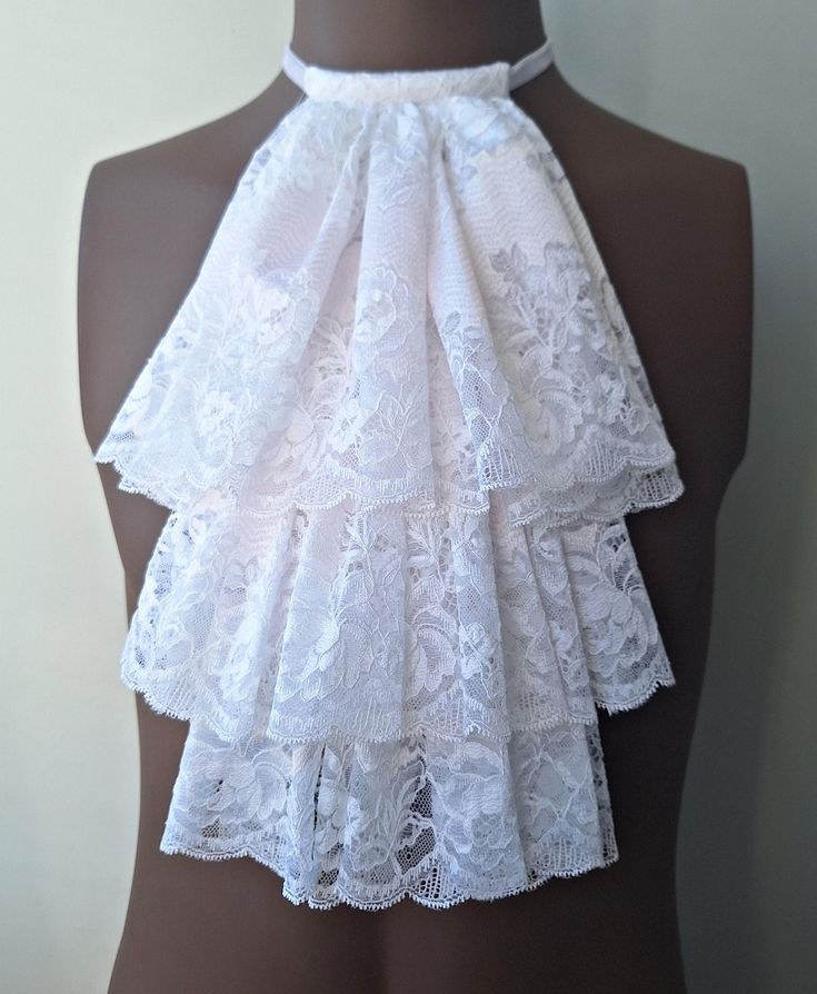 White lace jabot. Ideal accessory for a Steampunk wedding. Pirate party, vampire costume lace jabot. This jabot is made from high-quality lace and fits great with a blouse.  Fits all neck sizes.    Please check the size below. Jabot size: Length - 34cm (13.3") Width - 23cm (9.05") Hand washes. Lay on a flat surface to dry. In my photos, I always try to show the colors of my product as accurately as possible. The colors may vary depending on your screen. Shipping: worldwide from Europe (Latvia) w White Gothic Costume Accessories For Cosplay, Jabot Pattern, White Victorian Overbust Corset, White Victorian Blouses With Cleavage, Vampire Cosplay, White Victorian Blouse With Lace Trim, Blouse Fits, Pirate Cosplay, Vampire Costume