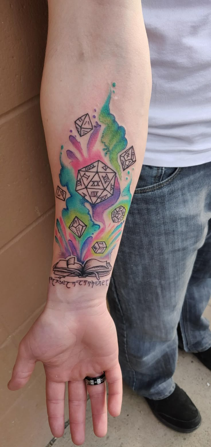 a person with a colorful tattoo on their arm holding his hand up to the camera