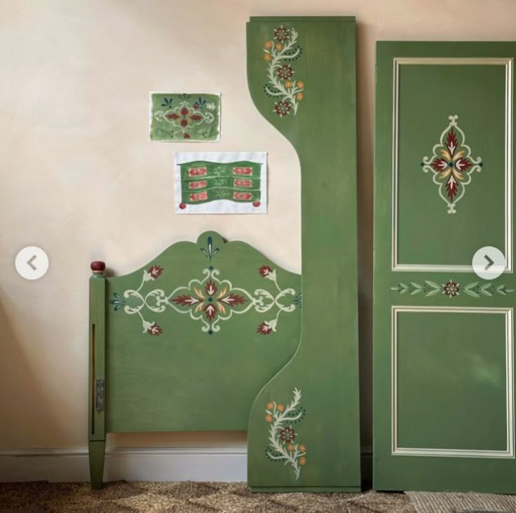 two green painted doors with designs on them