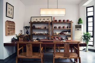 a dining room table with chairs and shelves