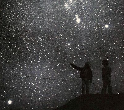 two people looking up at the stars in the sky