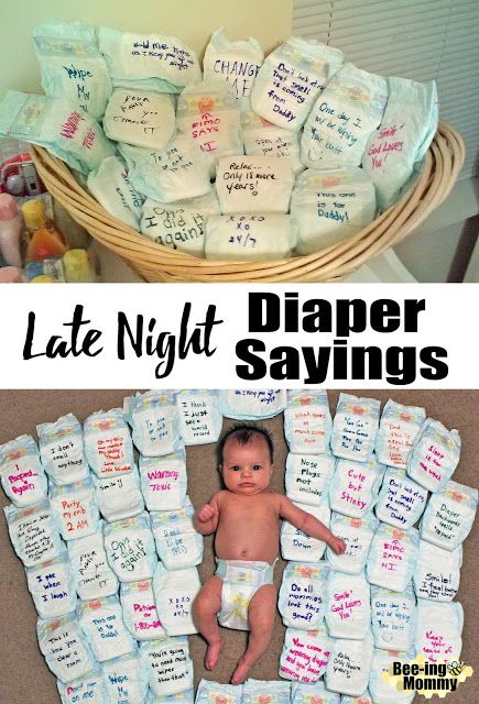 a baby in diapers is laying on the floor next to a basket full of diapers