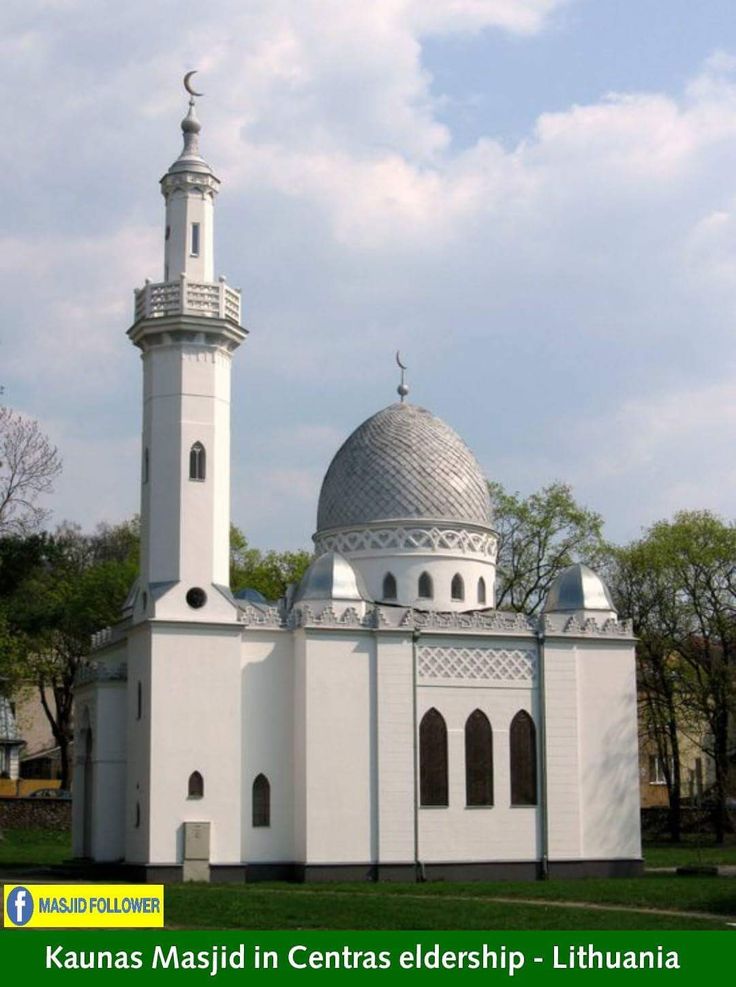 a large white building with a clock on it's side and a steeple