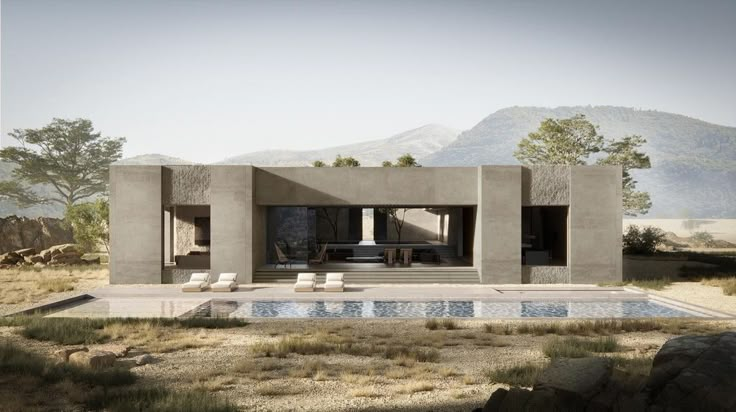 a house in the desert with a pool and lounge chairs on the ground next to it