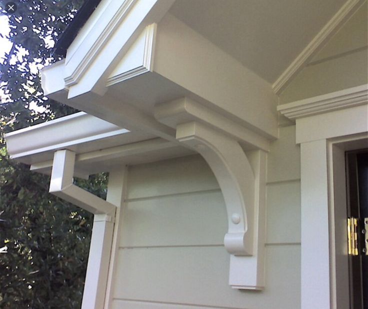 the corner of a house with an open window and gutter guard on it's side