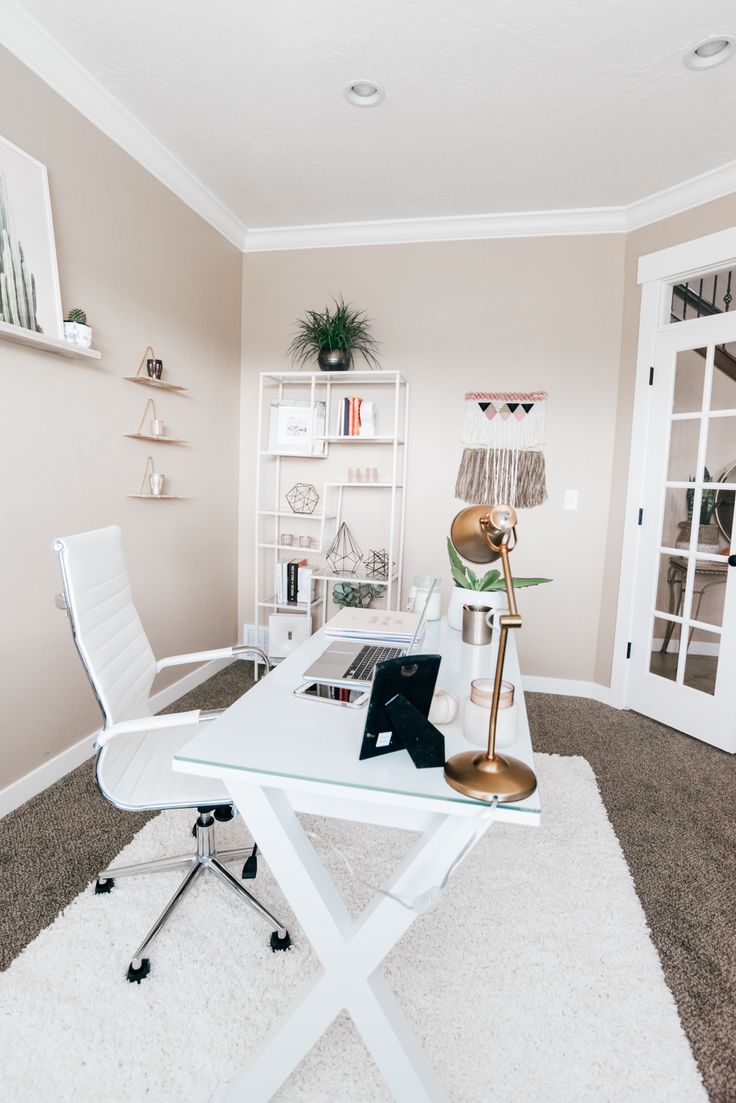 a white desk with a laptop on it