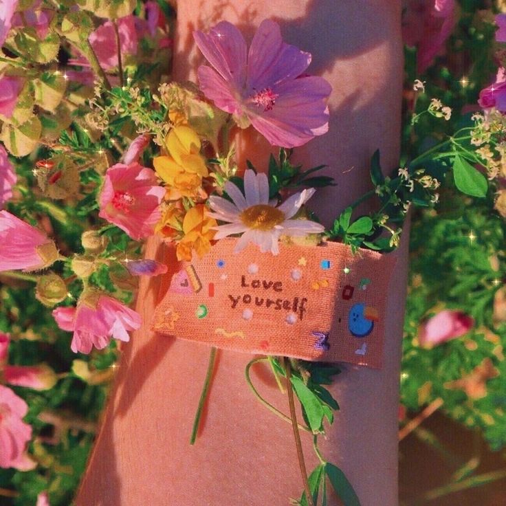 a pink dress with flowers on it and a love yourself tag attached to the back