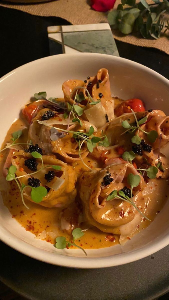 a white bowl filled with food on top of a table