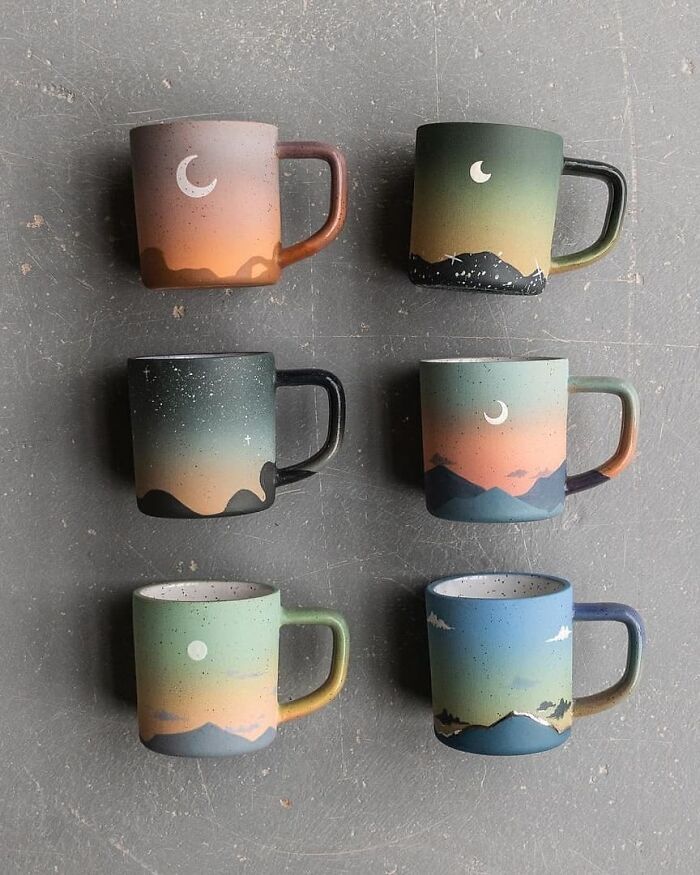 five coffee mugs with mountains and stars painted on them