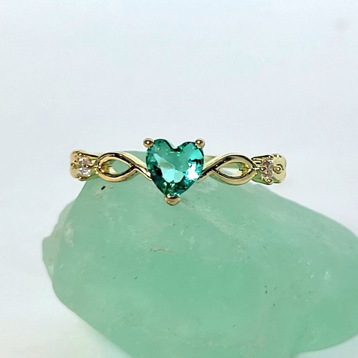 18k Yellow Gold Heart Shaped Emerald May Birthstone Delicate Dainty Ring Size 7 18k Yellow Gold Plated This Ring Is True To Its Beauty!!! The Detail And Sheer Sparkle Is Absolutely Stunning!! Wear Your Heart On Your Finger, Or Gift This To The Love Of Your Life! This Heart Shaped Solitaire Gemstone Sits Pretty On A 18k Yellow Gold Plated Band. This Lab Created Emerald Is A Shiny Green Gem Teeming With Fire And Brilliance. #Goldplated #Ringsize7 #Size8ring #Maybirthstone #Emerald Greenstone Yello Gold Gemstone Heart Ring For Promise, Elegant Green Heart Ring For Valentine's Day, Elegant Heart Ring With May Birthstone Gemstone, Elegant May Birthstone Heart Ring With Gemstone, Elegant Green Heart Promise Ring, Emerald Heart Promise Ring, Elegant Heart Ring For May Birthstone Gift, Heart-shaped May Birthstone Ring For Promise, Green Birthstone Heart Ring For Promise