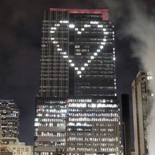 the skyscrapers are lit up at night in new york city