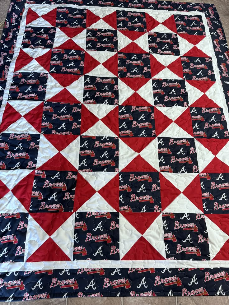 a red and white quilt with letters on it