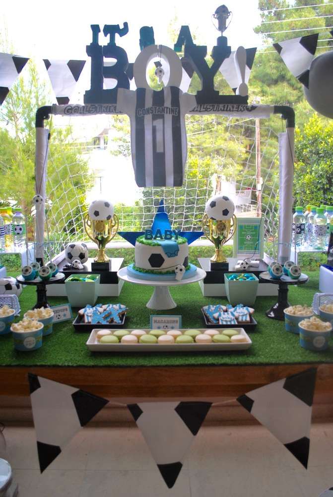 a soccer themed dessert table with cupcakes and snacks on it for boys birthday party