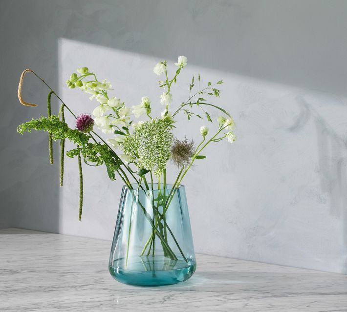 there is a vase with flowers in it on the table