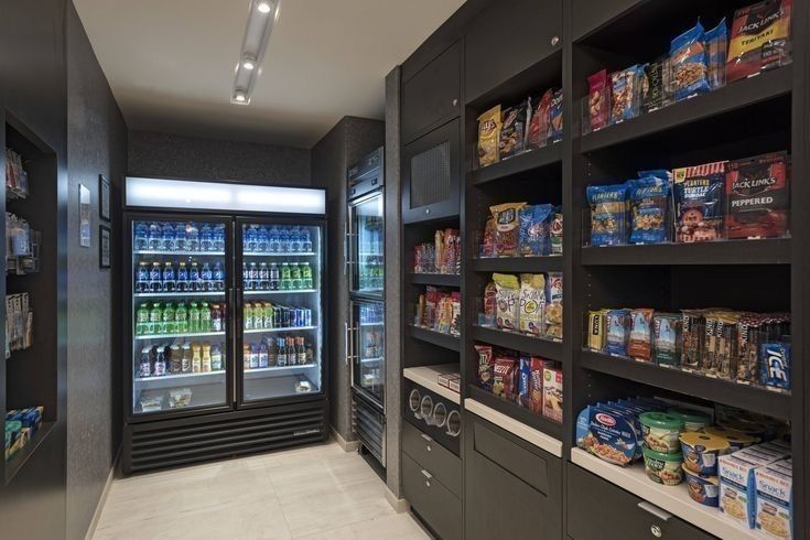 an empty grocery store filled with lots of food and drink bottles in the coolers