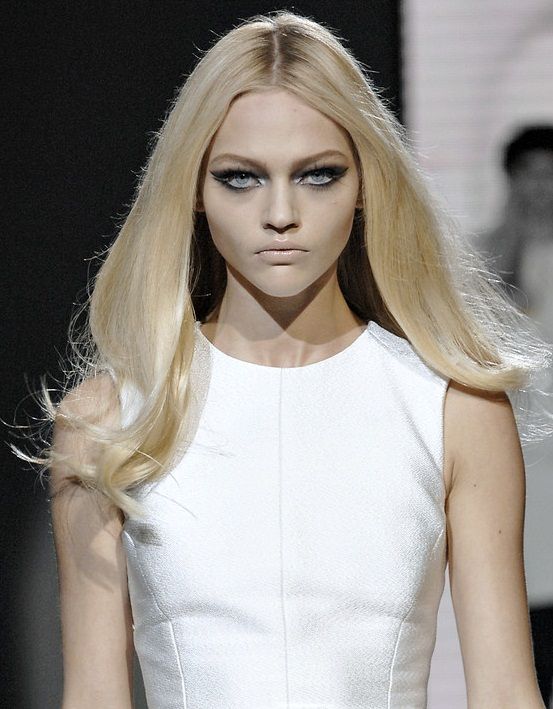 a model with long blonde hair and blue eyes