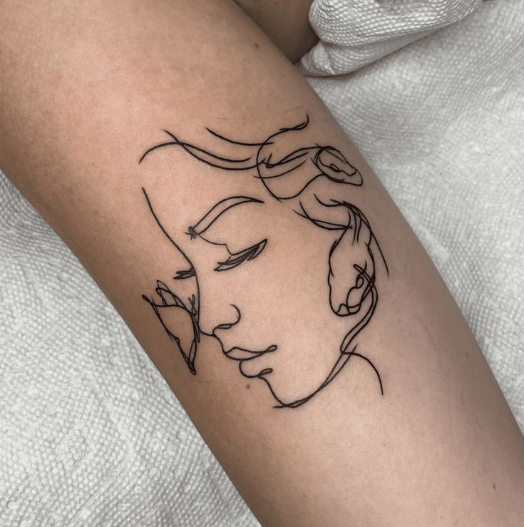 a woman's arm with a line drawing of her face on the left side