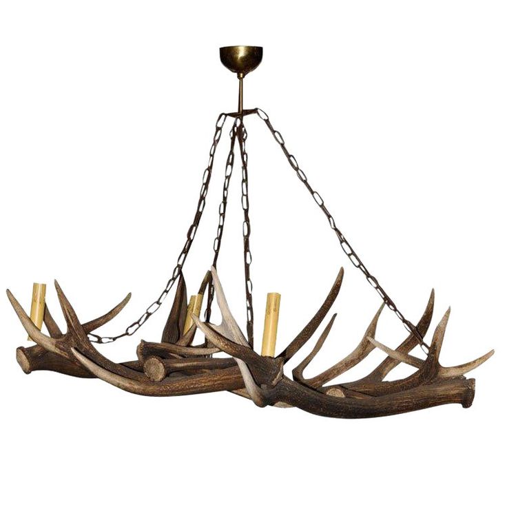 a chandelier with antlers hanging from it's sides and chains on the bottom