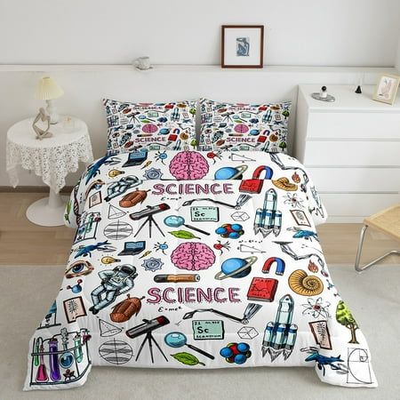 a bed with science themed sheets and pillow cases on top of it in a white room