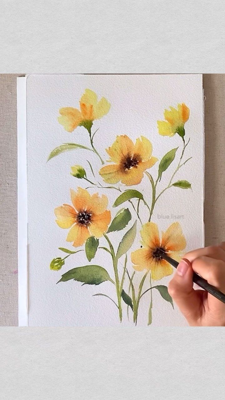 someone is painting flowers with watercolors on paper