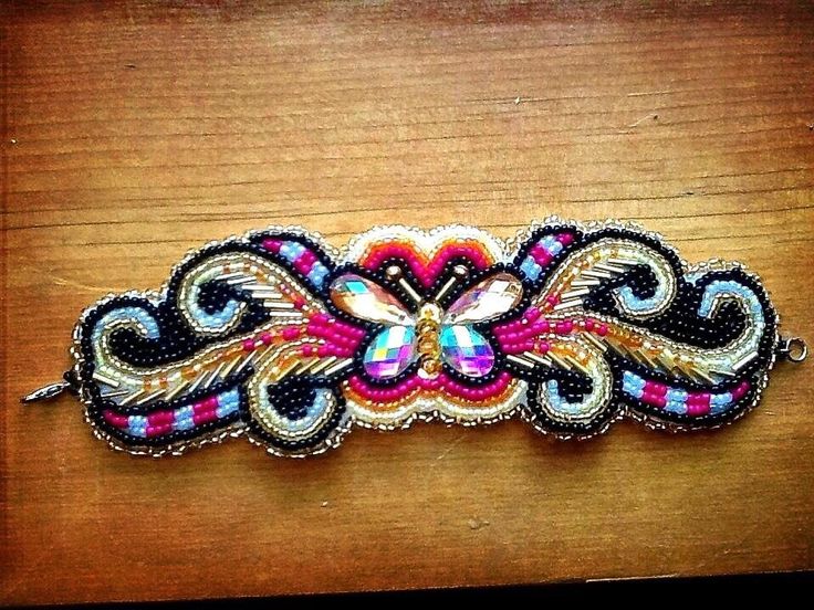 a colorful beaded headband on a wooden surface