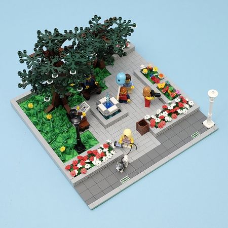 a lego model of a living room with plants and flowers on the floor, in front of a blue background