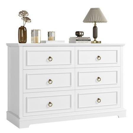 a white dresser with two lamps on top