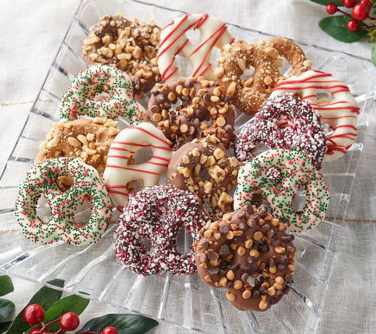 a glass platter filled with assorted pretzels and candy caned treats