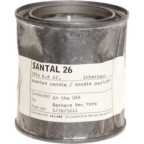 a candle that is inside of a metal can with labels on it and the words santal 26 written in white