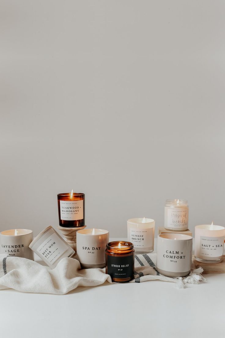 candles and towels on a white surface