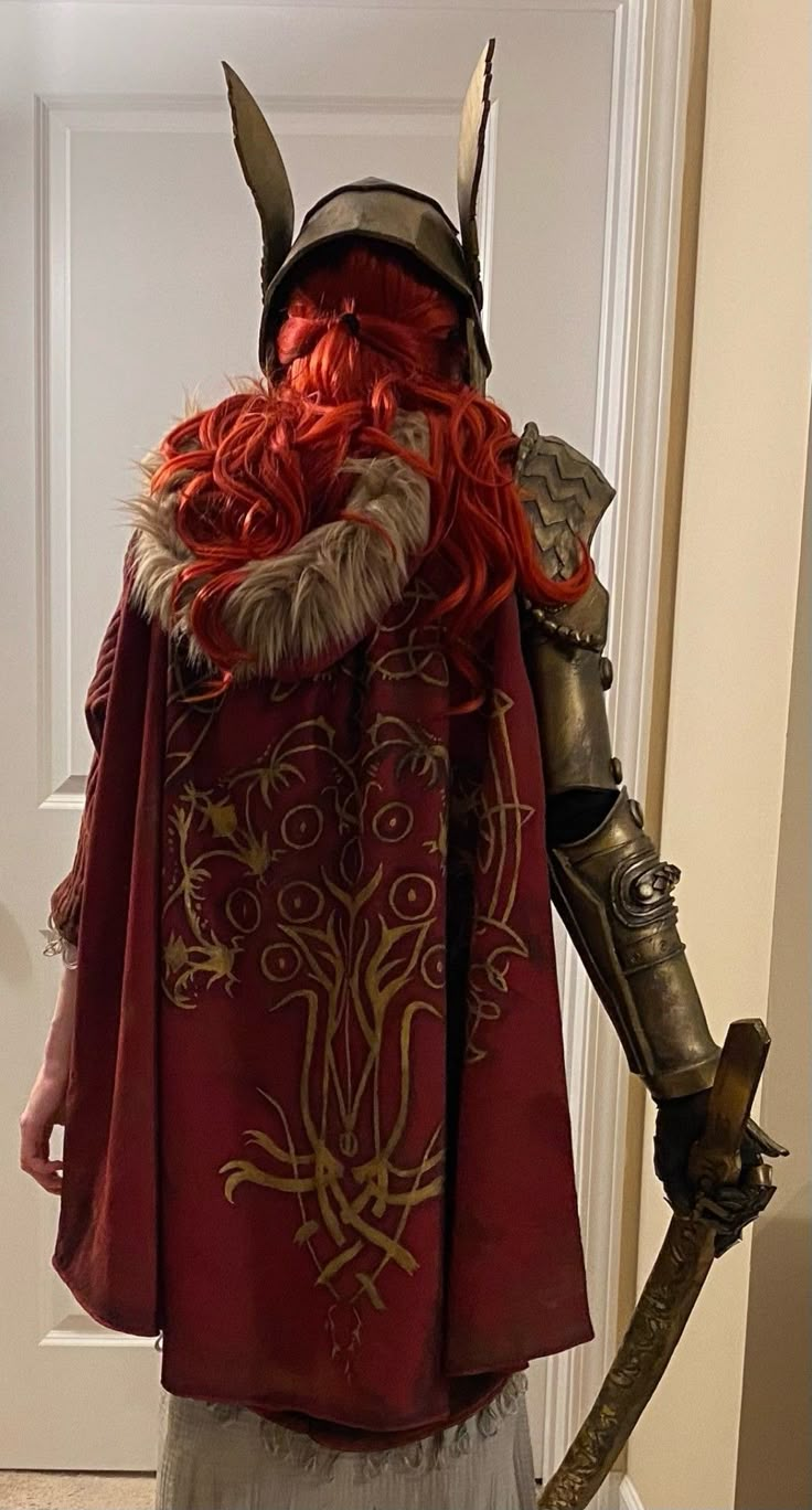 a man dressed as a viking with red hair and horns