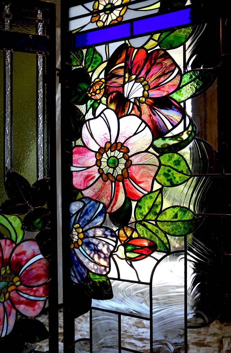 a stained glass window with flowers on it