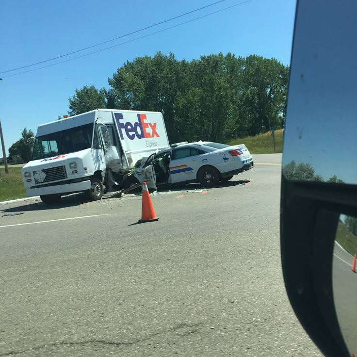 a fedex truck that has crashed into another car