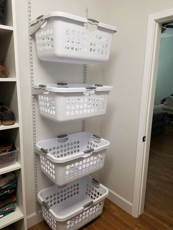 three white baskets are stacked on the wall next to each other in this walk - in closet