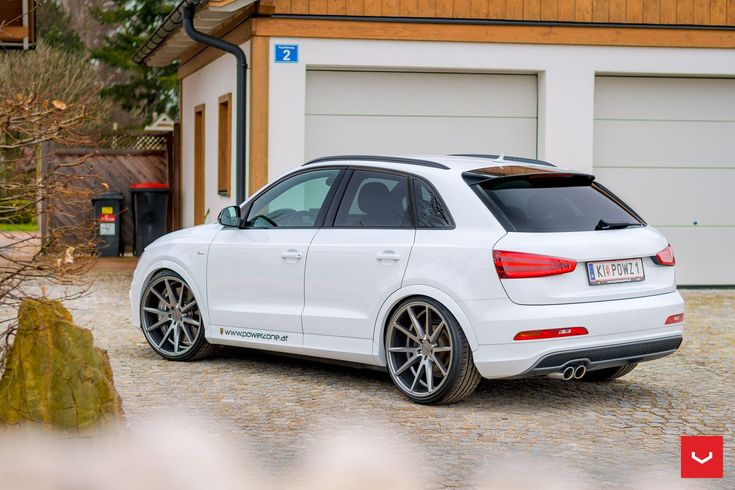 a white car parked in front of a garage