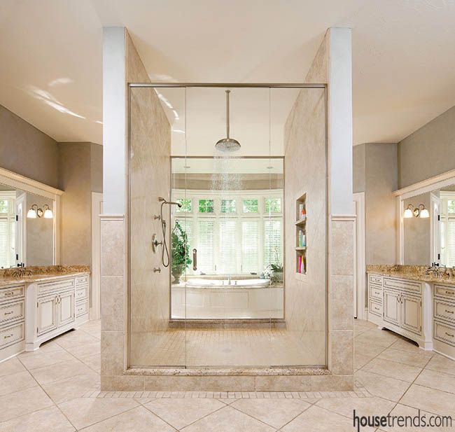 a large bathroom with two sinks and a walk in shower next to the bathtub