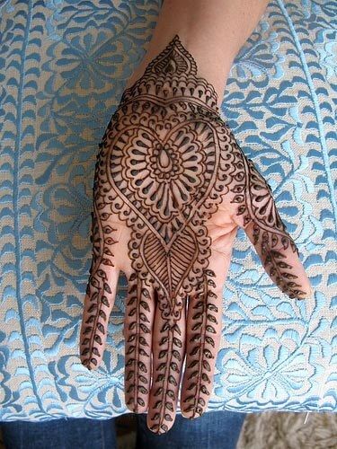 a woman's hand with hennap on it, showing the intricate design