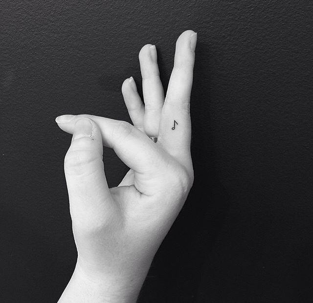 a black and white photo of someone's hand making the v sign with their fingers